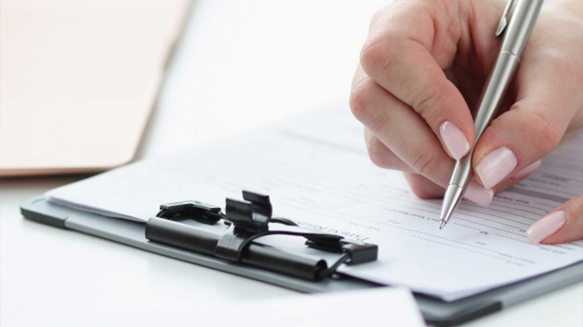 A person writing on a notepad