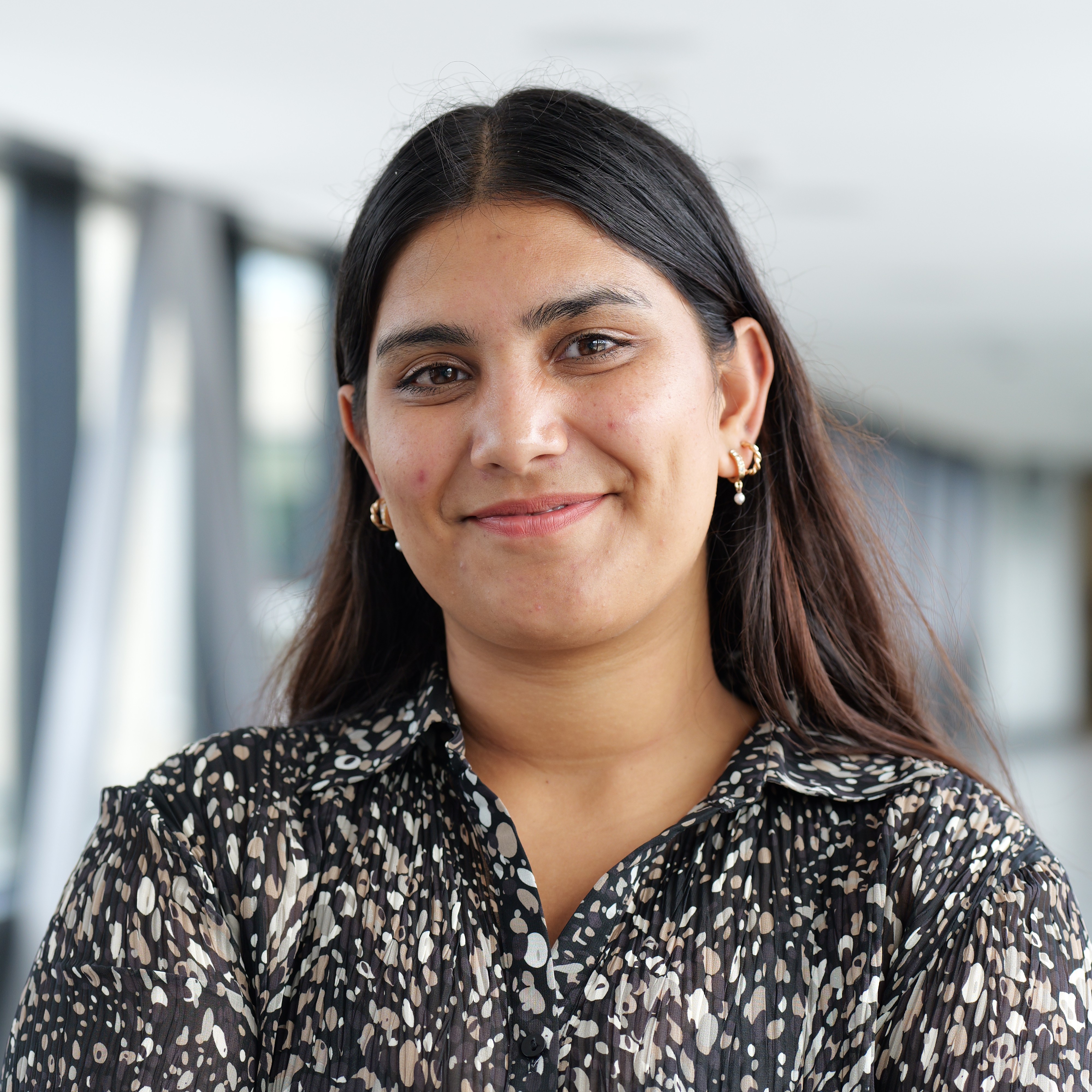 A picture of the current Vice-President Education - Akriti Shyam. She is an indian Woman, in a dark sparkly shirt, in her mid 20s, smiling at the viewer. 