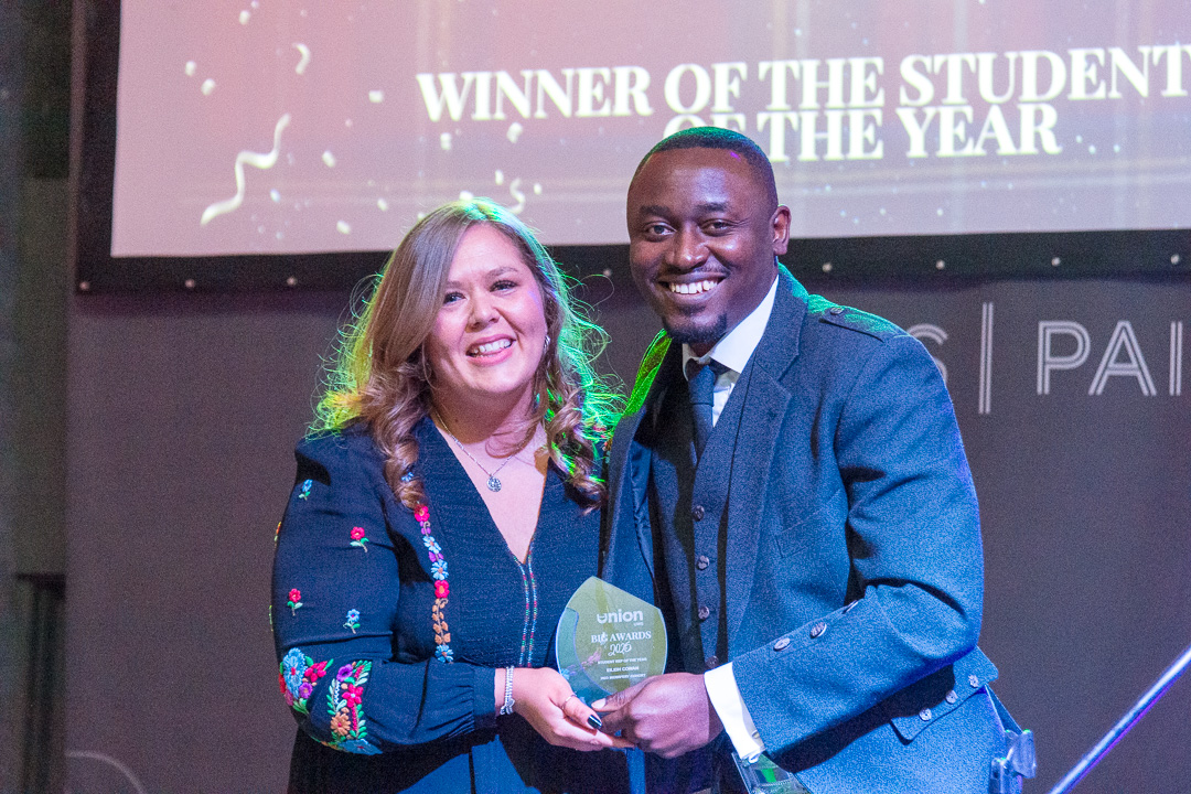 16 members of the UWS Indian Society smiling at the camera