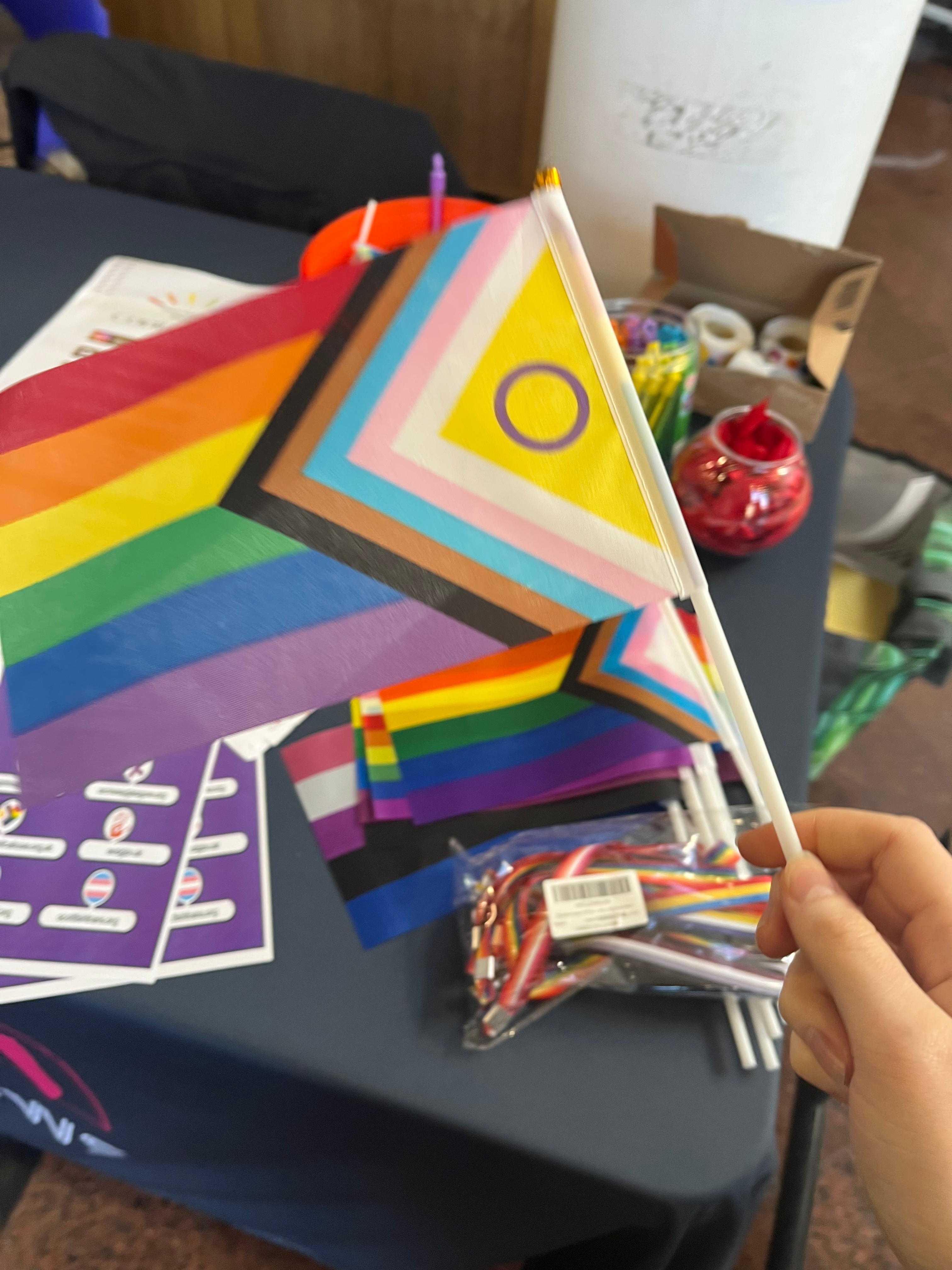 Photo of LGBTQ+ society stall with Liberation Flag in centre